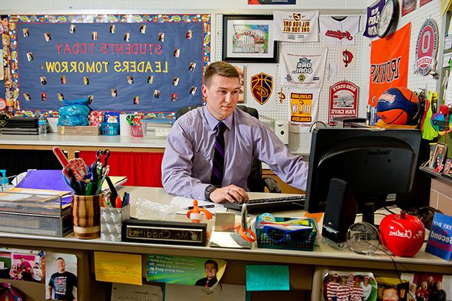 Teacher working on a computer at his desk